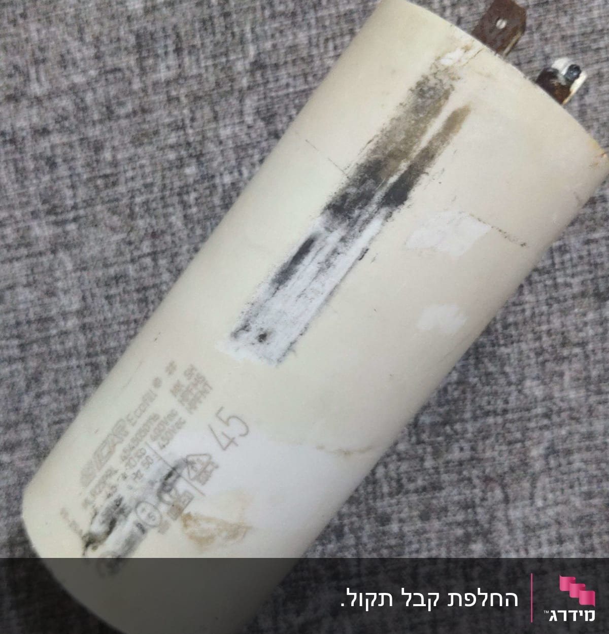 קבל חשמלי לבן עם כתמים ושני חיבורים